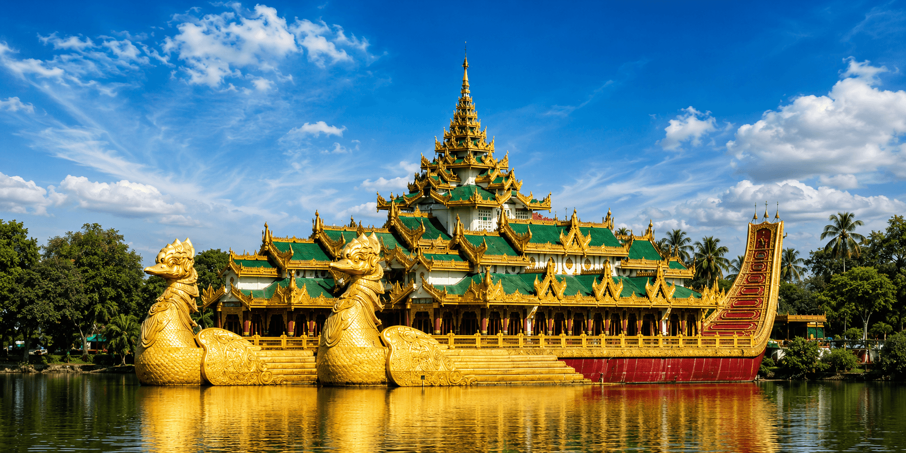 Karaweik palace beside Kandawgyi Lake under a blue sky